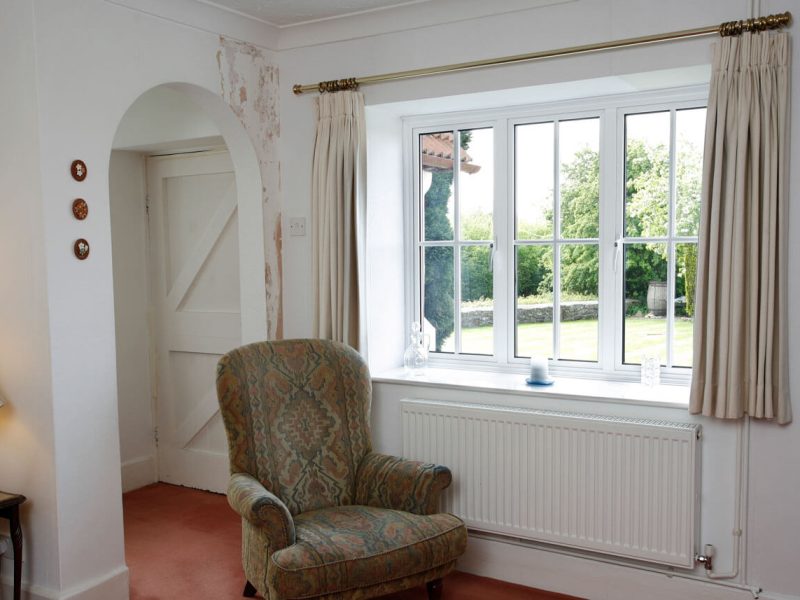 Old chair in a cottage by the new window